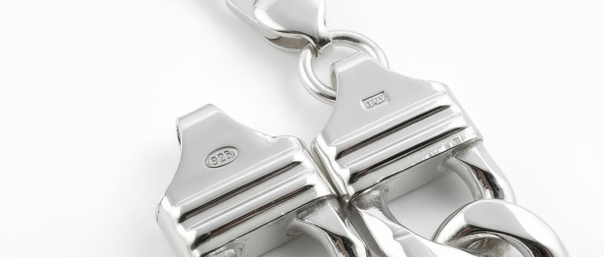 Macro of the 925 and Italy stamps on the end pieces of a Neviera sterling silver Cuban link chain.