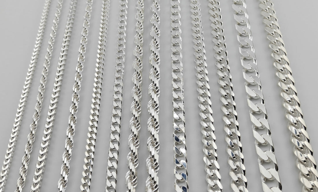 All thirteen Neviera silver chain widths laid side by side, from 3,8 mm Franco to 12,2 mm Cuban link, in solid 925 sterling silver