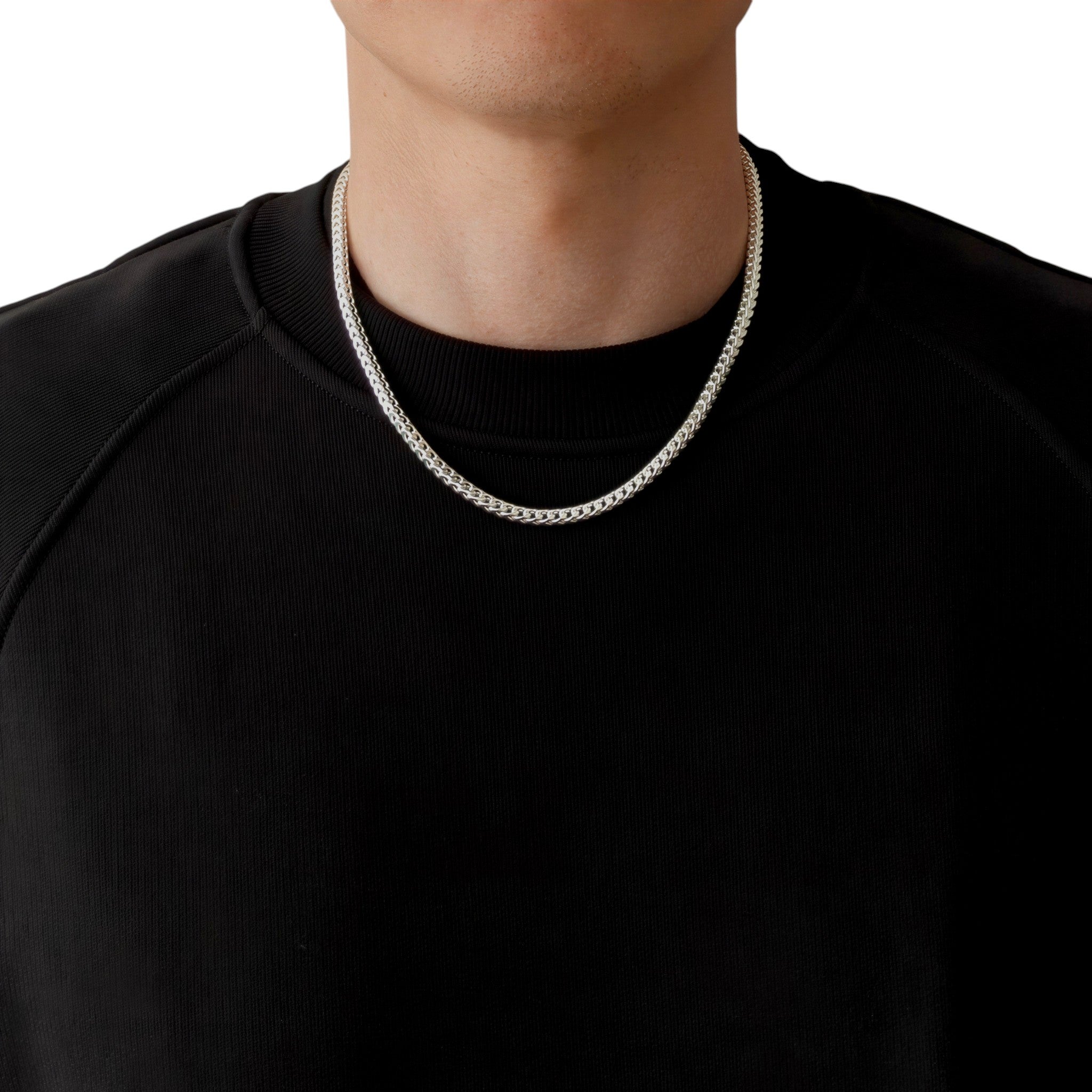 Neviera Franco chain necklace — Italian-made 925 sterling silver, 50cm length, 3,8mm width. Lifestyle photograph on model wearing the chain with a black crew-neck sweatshirt on a neutral background. Neviera specializes in high-quality Italian-made 925 silver chain necklaces and bracelets.