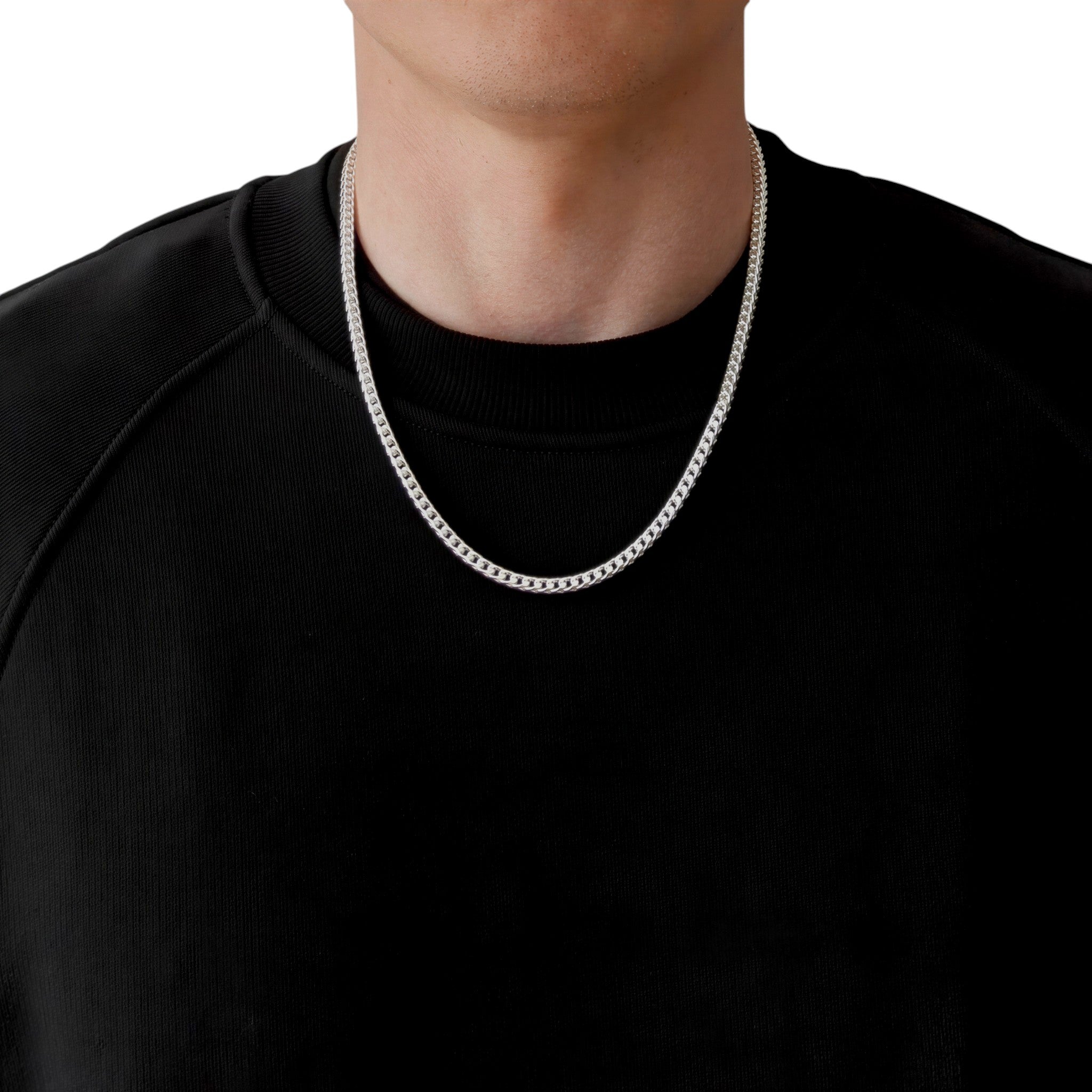 Neviera Franco chain necklace — Italian-made 925 sterling silver, 55cm length, 3,8mm width. Lifestyle photograph on model wearing the chain with a black crew-neck sweatshirt on a neutral background. Neviera specializes in high-quality Italian-made 925 silver chain necklaces and bracelets.