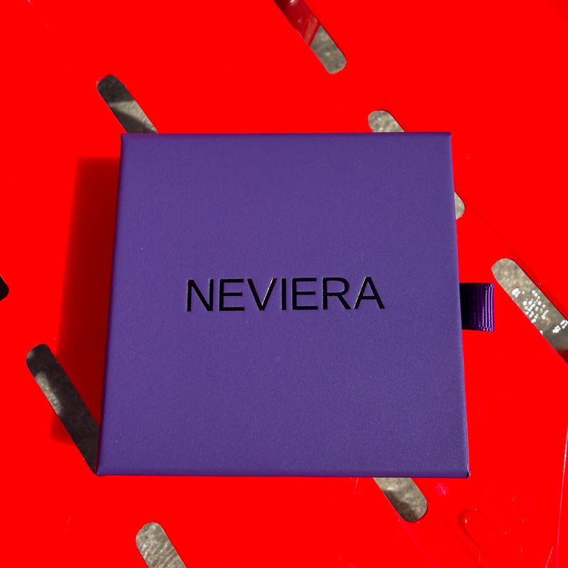 Neviera Signature Box On Top of a Red Plastic Chair