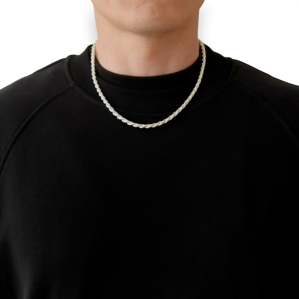 Neviera rope chain necklace — Italian-made 925 sterling silver, 50cm length, 4,6mm width. Lifestyle photograph on model wearing the chain with a black crew-neck sweatshirt on a neutral background. Neviera specializes in high-quality Italian-made 925 silver chain necklaces and bracelets.